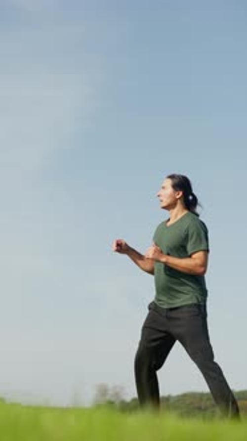 Young Adult Practicing Martial Arts Moves Outdoors
