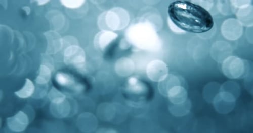 Many water bubbles in blue water close up, abstract water wave with bubbles in slow motion.