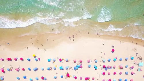 Mediterranean beach during summer with people in the water