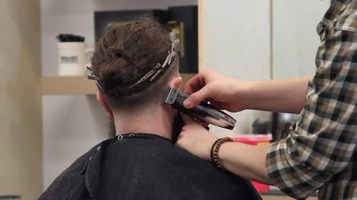 Barber Giving a Haircut With Electric Razor