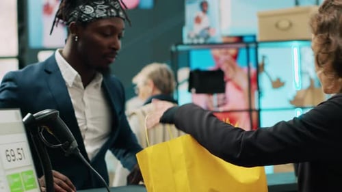 African American Client Paying with Card at Pos in Clothing Store
