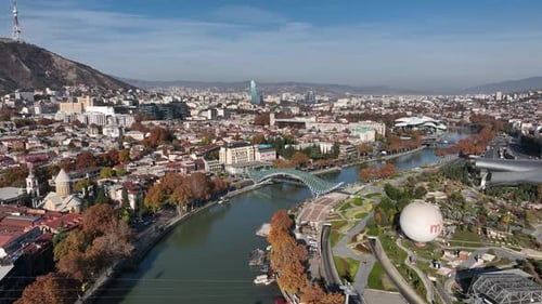 Aerial view of Tbilisi city central park and Bridge of Peace. Beautiful cityscape of old Tbilisi