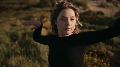 Artistic Dancer Posing Gracefully in Scenic Field