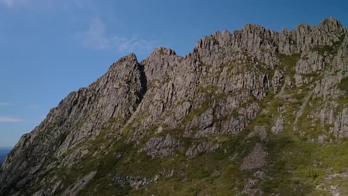 Profile view of rough cliffs of hills on sunny day. Drone shot.