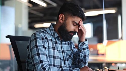 Tired Businessman in Office Suffering From Headache and Stress