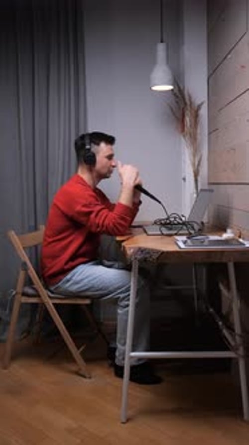 Young Man Recording Audio in Home Studio