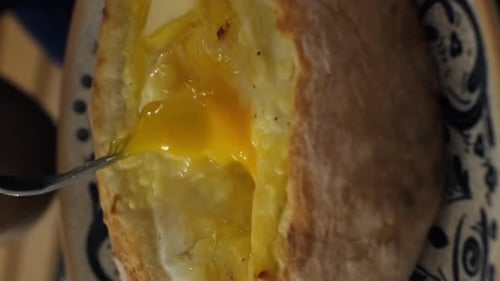 Mixing Egg Yolk into Cheesy Bread Bowl