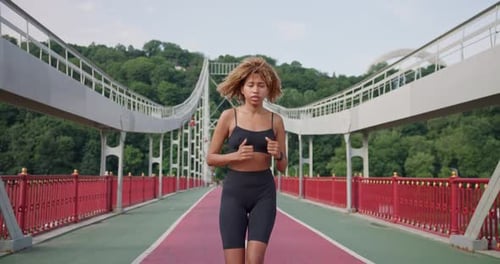 Sporty African American Woman Looking at Her Sport Bracelet on Hand Checking Data on Fitness Tracker