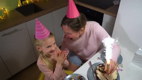 Mother and Daughter Celebrate Birthday with Cake
