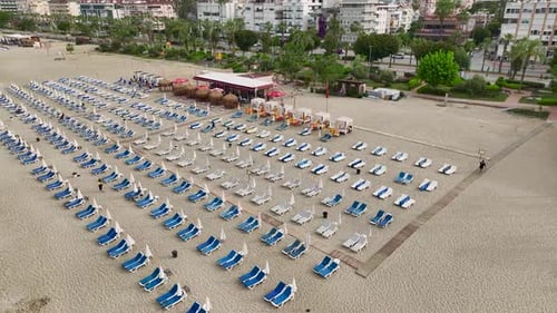 Aerial Video of Seaside Beach Organized with Rows of Loungers and Cabanas