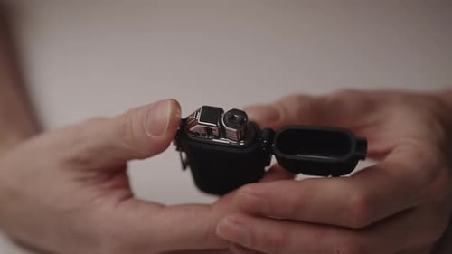Male Hands Opening Electronic Flameless Lighter Activating Plasma Arc with Modern Usb Rechargeable
