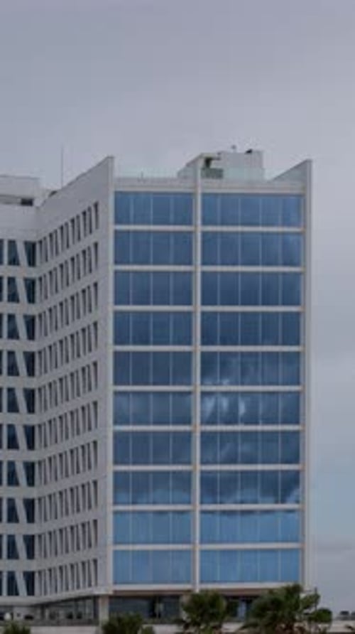 Clouds Passing in Reflection of Glass Windows of Skyscraper