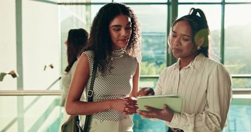 Stylish Women Looking at Tablet and Talking