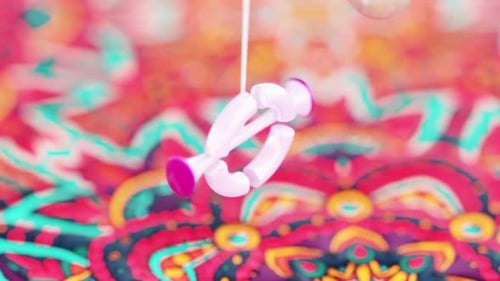 3D Rendering Loop of Hanging Objects Swinging Through Ring Above Rangoli