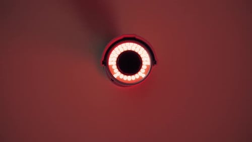 Modern Security Camera Swiveling with Pulsing Red Light
