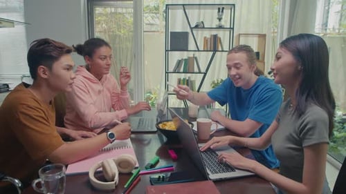 Four Young Adults Studying and Working Together