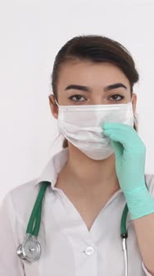 Medical Professional Wearing Mask Adjusts for Safety