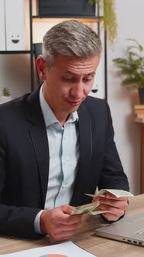Upset Businessman Freelancer Counting Dollar Cash Insufficient Amount of Money at Home Office Desk