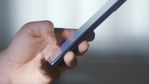 Close-up of the message typed on the phone's keyboard.