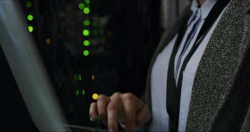 Woman Types on Laptop in Data Center