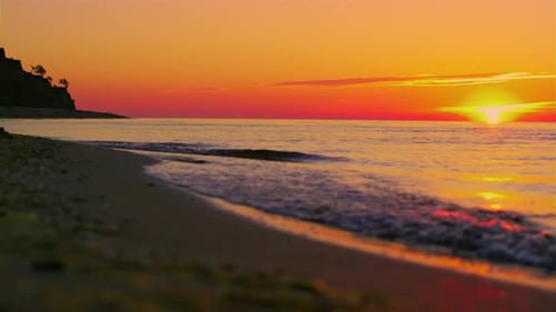 Panoramic Landscape Rock Silhouette at Orange Sunrise Morning. Ocean Wave Splashing Sand
