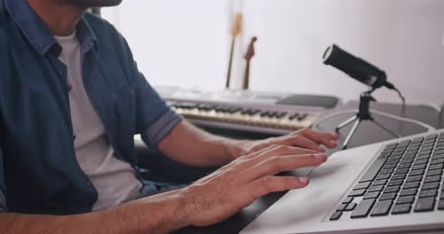Asian musician is creating new music in his home studio.