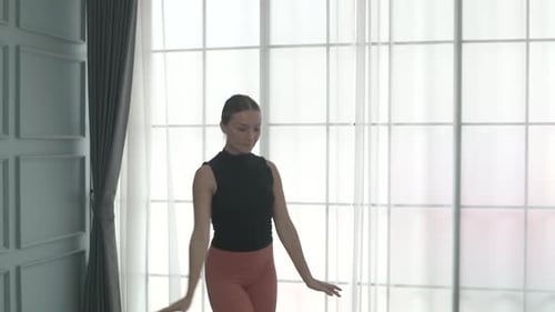 Friends practice ballet dance at studio.