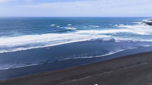Aerial view of black sand beach and waves, Iceland.