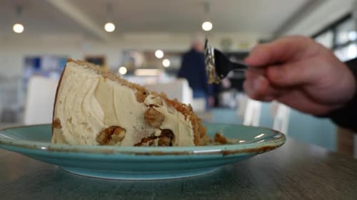Eating cake with a fork in a cafe restaurant