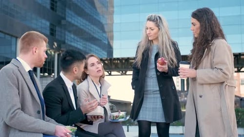 Businesspeople on Lunch Break Talk Relax and Laugh Outside Office Building