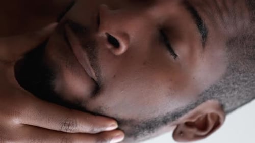 Handsome Bearded Man Touching Face in Close Up