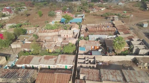 Drone shot flying over huts and buildings in a small and remote African village