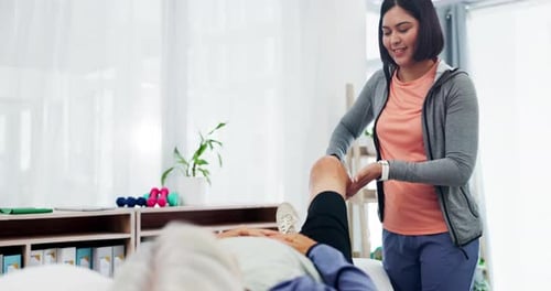 Physical Therapist Helping Senior Woman with Knee Rehabilitation