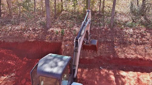 Excavator Digging Trench in Rural Forest, Aerial
