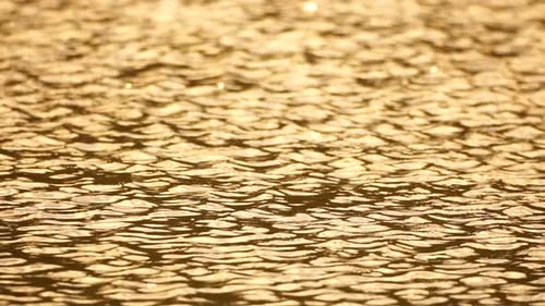 Sun Reflecting on Sparkling Sea Lake Water Surface Ocean at Sunset Sunrise Sunrays Flickering in