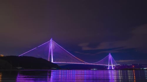 Futuristic Bridge Lit Up at Night over Water