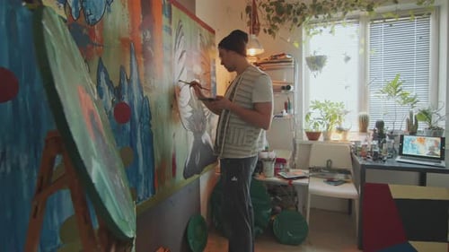 Artist Painting Large Abstract Artwork in Cozy Creative Studio