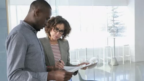 Business professionals teamwork and collaboration reviewing paperwork in the office