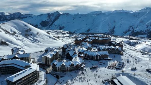 aerial shot of Snowy Mountain Resort with Skiers Gathering