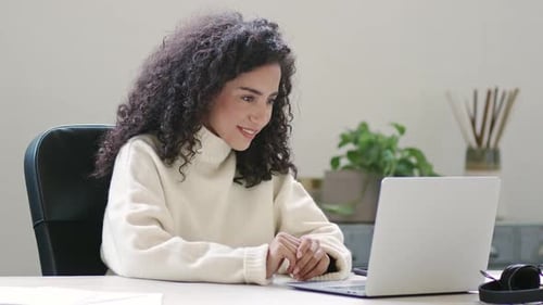Woman Working on Laptop in Bright Office