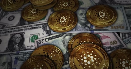 Cardano ADA cryptocurrency coin over Dollar banknotes looped