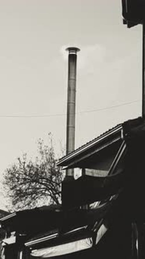 Industrial chimney emitting smoke in Konya Turkey monochrome scene