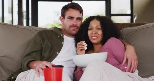 Romantic Couple Cuddling While Watching TV