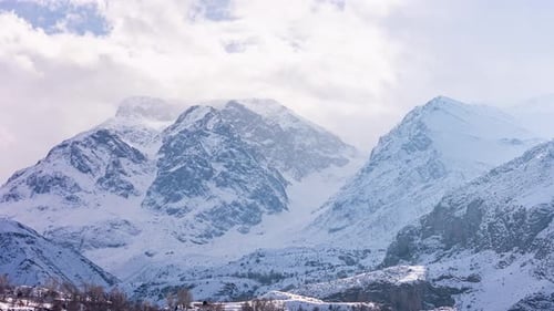 Snow-Covered Mountain Peaks in Winter Fog