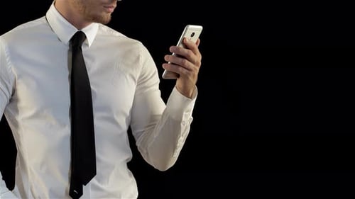Confident Man Lifting Smartphone with Style