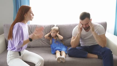 Family Dispute On Sofa in Bright Living Room