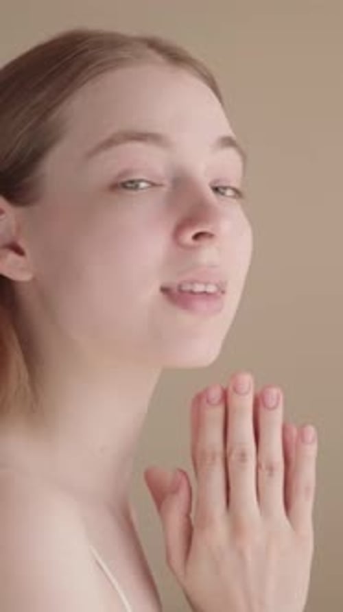 Beautiful Woman Massaging Her Face in Relaxing Home Setting