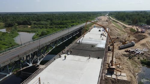 Aerial View of the Construction of a New Transport Bridge Across a Wide River