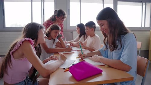 Female Primary School Teacher Explaining in Class to Diverse Group of Students