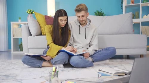 Young Couple Studying Together in Cozy Living Room